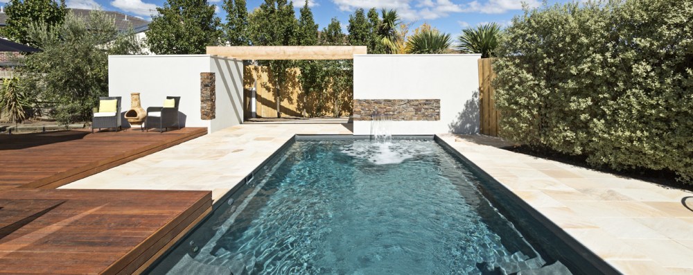 Compass fibreglass swimming pool with tiling and timber deck